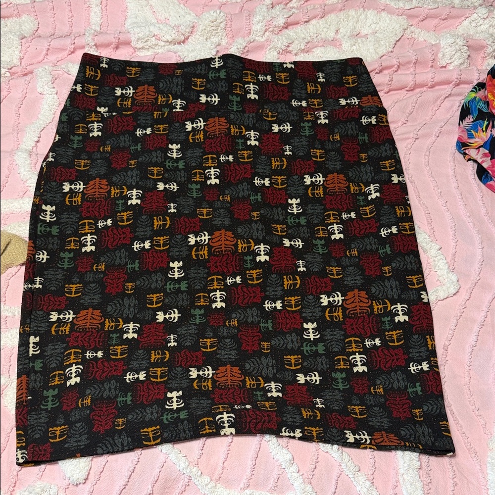 LuLaRoe Black Pencil Skirt with Red, Orange, Cream & Green Accent Print